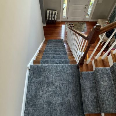 stair runner installation with grey carpet and hardwood stairs in Bethlehem, PA